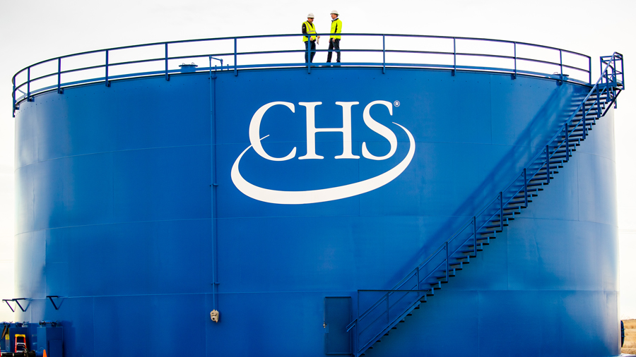 Employees at top of CHS branded storage bin